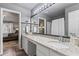 Double vanity bathroom with granite countertops and a view to the bedroom at 54 Devonshire Dr, Alpharetta, GA 30022