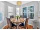 Charming dining area with a round table and four leather chairs near a bay window at 2713 Windsor Nw Ct, Kennesaw, GA 30144