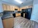 Kitchen with wood cabinets, granite counters and black appliances at 5464 Sierra Trl, College Park, GA 30349