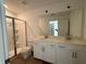 Bathroom boasts double vanity, a large mirror, and a shower at 2114 Stillhaven Pl, Douglasville, GA 30135