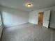 Spacious bedroom with carpet and an open door to a hallway at 2114 Stillhaven Pl, Douglasville, GA 30135