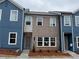 Two-story townhome, blue and brick exterior at 2114 Stillhaven Pl, Douglasville, GA 30135