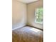 Bright bedroom featuring neutral wall paint and carpeted floors at 478 Charleston Pl, Villa Rica, GA 30180