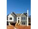 Two-story house with gray and white siding, a wooden staircase, and a partially visible attached garage at 478 Charleston Pl, Villa Rica, GA 30180