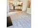 Living room with a view into the kitchen and carpeted floors at 478 Charleston Pl, Villa Rica, GA 30180