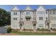 Three-story townhouses with gray siding, black accents, and a fenced yard at 4822 Floydwood Ln, Mableton, GA 30126