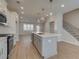 Modern kitchen with white cabinets, gray island, stainless steel appliances, and hardwood floors at 4822 Floydwood Ln, Mableton, GA 30126