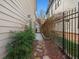 Stone path leads to a fenced backyard with landscaping and artificial turf at 627 Mead Se St, Atlanta, GA 30312