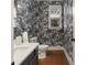 Small bathroom with palm tree wallpaper, modern vanity, and toilet at 627 Mead Se St, Atlanta, GA 30312