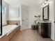 Elegant bathroom featuring a soaking tub, double vanity, and large mirror at 627 Mead Se St, Atlanta, GA 30312