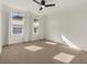 Bright bedroom with neutral carpeting, ceiling fan, and two large windows at 627 Mead Se St, Atlanta, GA 30312