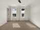 Well-lit bedroom with neutral carpeting, ceiling fan, and two windows at 627 Mead Se St, Atlanta, GA 30312