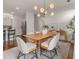 Open concept dining room with hardwood floors, modern light fixture and kitchen views at 627 Mead Se St, Atlanta, GA 30312