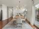 Light-filled dining area with hardwood floors, modern chandelier and access to backyard at 627 Mead Se St, Atlanta, GA 30312