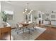 Bright dining room features hardwood floors, modern light fixture and seating for six at 627 Mead Se St, Atlanta, GA 30312