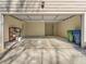 Spacious garage with open door, concrete floor, and storage shelving at 627 Mead Se St, Atlanta, GA 30312