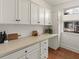 White kitchen cabinets, quartz countertops and hardwood floors at 627 Mead Se St, Atlanta, GA 30312