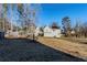 Large backyard with shed and tree-lined borders at 3727 Conley Downs Ln, Decatur, GA 30034