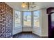 Bright dining area with brick accent wall and bay window at 3727 Conley Downs Ln, Decatur, GA 30034