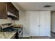 Kitchen features dark brown cabinets and granite countertops at 3727 Conley Downs Ln, Decatur, GA 30034