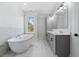 Modern bathroom with double vanity, soaking tub, and marble tile at 622 Bellemeade Nw Ave # 9, Atlanta, GA 30318