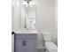 Small bathroom with purple vanity, white toilet, and a large mirror at 622 Bellemeade Nw Ave # 9, Atlanta, GA 30318