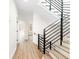 Light hallway with hardwood floors and modern staircase at 622 Bellemeade Nw Ave # 9, Atlanta, GA 30318