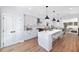 Modern white kitchen with large island and hardwood floors at 622 Bellemeade Nw Ave # 9, Atlanta, GA 30318