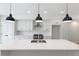 Modern kitchen island with white quartz countertop and black pendant lighting at 622 Bellemeade Nw Ave # 9, Atlanta, GA 30318