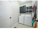 Laundry room with washer, dryer, cabinets and shelving at 11060 Pinewalk Forest Cir, Alpharetta, GA 30022