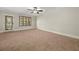 Spacious bedroom with carpeted floors, door to patio, and ceiling fan at 5579 Julian Pl, Atlanta, GA 30342