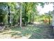 Spacious backyard with mature trees and a fenced perimeter at 207 Okemah Se Trl, Marietta, GA 30060