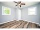 Spacious bedroom with ceiling fan, wood-look flooring, and ample natural light at 207 Okemah Se Trl, Marietta, GA 30060