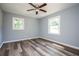 Bright bedroom with ceiling fan, wood-look flooring, and large windows at 207 Okemah Se Trl, Marietta, GA 30060