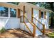 Front porch with wooden stairs and railing, leading to the entrance of the house at 207 Okemah Se Trl, Marietta, GA 30060