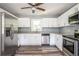 Modern kitchen with white shaker cabinets, stainless steel appliances, and granite countertops at 207 Okemah Se Trl, Marietta, GA 30060