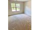 Spacious carpeted bedroom with large window and neutral walls at 482 Charleston Pl, Villa Rica, GA 30180