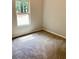 Well-lit bedroom featuring carpet and a window at 482 Charleston Pl, Villa Rica, GA 30180