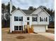 Charming two-story home with white siding, black shutters, and an attached two-car garage at 482 Charleston Pl, Villa Rica, GA 30180