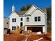 Two-story house with gray and white siding, a two-car garage, and a wooden staircase at 482 Charleston Pl, Villa Rica, GA 30180