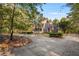 Brick home with wraparound porch and landscaped yard at 3282 Callie Still Rd, Lawrenceville, GA 30045