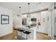 Modern kitchen with white cabinets, marble countertops and island at 403 Pratt Se Dr # 1009, Atlanta, GA 30315
