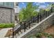 Stone steps with metal railing leading to townhouse entrance at 403 Pratt Se Dr # 1009, Atlanta, GA 30315