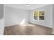 Well-lit bedroom with hardwood floors and a large window at 57 Rocking Wood Vw, Dallas, GA 30157