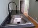 Stainless steel sink with modern black gooseneck faucet in laundry area at 1616 Oleander Sw Dr, Lilburn, GA 30047