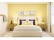 Cozy bedroom with yellow walls, white bed, and two nightstands at 2803 Habibi Ct, Buford, GA 30519