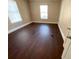 Spacious bedroom with hardwood floors and two windows at 1294 N Avenue Nw, Atlanta, GA 30318