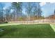 Spacious backyard with a wooden fence and large grassy area at 2336 Morgan Estate Dr, Buford, GA 30519