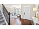 Hardwood floor entryway with staircase and view into playroom at 2336 Morgan Estate Dr, Buford, GA 30519