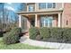 Inviting front porch with brick columns and landscaping at 2336 Morgan Estate Dr, Buford, GA 30519